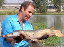 Robson Green with an alligator gar from IT Lake Monster